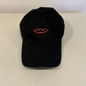 The Classics black baseball cap with orange smiley face